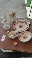 All items: two oval platters, two oval bowls, gravy boat with underplate, coffee pot, crystal globe lamp, tiny teacup