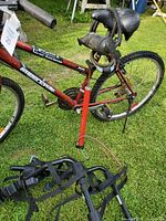 Close-up of the red Schwinn mountain bike with rear tire pump and black saddle cover