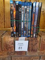 Photo of 12 Blu-ray and DVD sci-fi and action movies stacked together with visible spines showing titles.