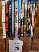 Blu-ray and DVD spines aligned showing titles including The Heat, 5000 Degrees, A Star Is Born, Safe House, and others.
