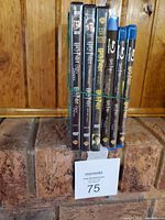 Photo showing the six Harry Potter DVD and Blu-ray cases standing together, three DVDs and three Blu-rays, secured with a rubber band.