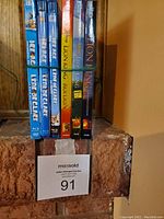 Side view of Blu-ray and DVD cases showing movie titles Ice Age and Lion King series.