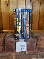 Photo showing eight Blu-ray and DVD movie cases including Taken 3, Non-Stop, The Darkest Hour, Olympus Has Fallen