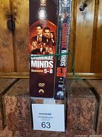 Two Criminal Minds DVD sets stacked: Seasons 5-8 in a larger box with slipcase, and Season 1 DVD in case beside it