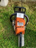 Front top view of chainsaw showing housing, model label and QuickStop feature