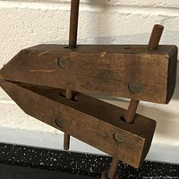 Side view of the wooden woodworking clamp with metal screws and Jorgensen branding