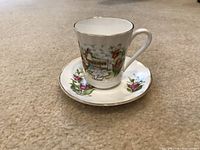 Fine bone china coffee cup and saucer with PEI themed decoration and floral accents