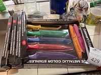 Cuisinart color-coded knife set in packaging with blade guards and extra boxed blades