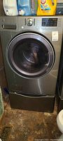 Front view of stainless steel front-loading washer showing door and control panel