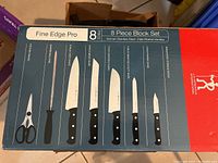 Box of Fine Edge Pro 8-piece stainless steel knife block set with various knives and scissors shown on front of box.