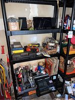 Wide view of shelving unit with various tools, audio equipment, vinyl records, and miscellaneous items.