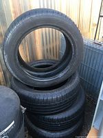 Photo showing four stacked black Mastercraft tires with visible tread, size markings 215/55 R17, suitable for mud and snow usage.