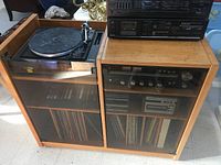 Overall view of stereo system and Swiss teak cabinet showing turntable on top and storage with glass doors below