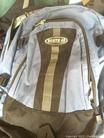 Close-up of blue North 49 backpack showing main compartment zipper and logo patch