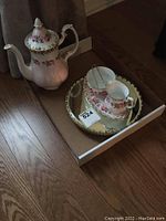 Photo of Royal Albert coffee pot, creamer, sugar dish, small platter on mirror tray inside box