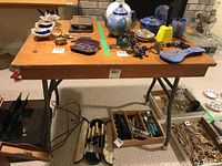 Top view showing wooden table surface with scratches and various small items placed on it.