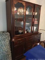 Full view of the assembled Gibbard buffet and hutch showing dark wood finish, glass display doors, and metal hardware.