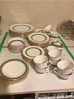 Full set arranged showing cups, saucers, stacks of plates and serving pieces