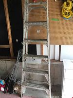 Front view of 8-step aluminum ladder showing steps and wear