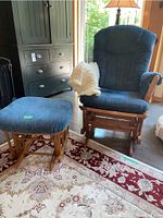 Full view of glider chair, ottoman and throw in room setting