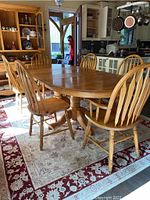 Full view of table with one leaf attached and six chairs around
