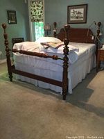 Full view of queen bed with frame, mattress, bedding and heated mattress cover