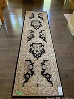 Full-length view of the hall runner on wood floor showing overall pattern and coloration