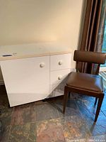 Front view of sewing table and chair in room setting