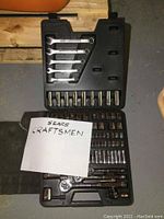 Overview photo of Craftsman socket and wrench set in black plastic case with folded magnetic tool strip on the side, includes handwritten noted 'Sears Craftsmen'