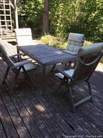 Full set on deck showing table and four chairs