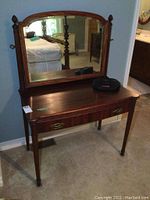 Full front view of vanity with mirror mounted, shows drawer and hardware