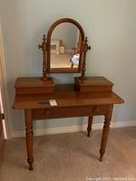 Full front view of vanity with mirror and storage boxes