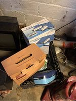 Photo of lot showing cardboard boxes for Marnur Air Pressure Mattress, Proactive Protekt Aire 1500, and Vios aerosol delivery system with blue Drive air pump in basket.