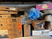 Photo of several stacked boxes labeled with various markings and some packaging materials visible