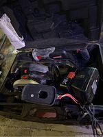 Set of Craftsman power tools and accessories inside black plastic carrying case. Includes reciprocating saw, circular saw, battery, and charger.