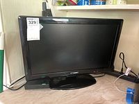 Front view of Polaroid 22-inch TV showing screen and base stand.