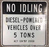 Front view of metal street sign with the main text 'NO IDLING DIESEL-POWERED VEHICLES OVER 5 TONS ACT 124 OF 2008'. Paint shows wear and peeling on top left corner.