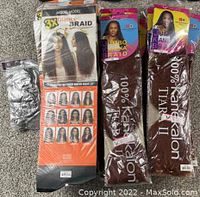 Front view of hair braids lot showing 3x Glance Braid, Jumbo Kaneka Braid and parts of additional packages in original packaging.