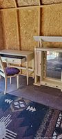 Vanity desk with chair and lighted mirror shelf in storage setting