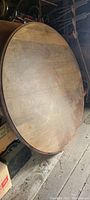 Top side of the round wooden table showing surface wear