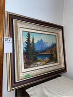 Framed landscape painting showing the entire frame and part of room