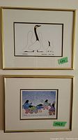 Photo showing two framed prints side by side: top print "Learning" shows stylized birds, bottom print "Winter Dancers" shows Indigenous dancers in colorful outfits.