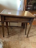 Full view of the larger rectangular wooden table showing top and legs.