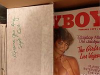 Close-up of a box lid with handwritten notes listing missing months for 1979: "Missing Jan Aug Sept Oct," with the February 1979 Playboy cover partially visible.