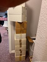 Stack of ten boxes labeled with years 1990 through 1999 containing magazines.