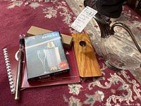 Image showing vintage decanter next to wine aerator, Rapid Ice box, and two wine notebooks on a patterned rug