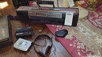 Full view of boombox, two Walkman devices, one Sony headset, and one Sennheiser earphones on table
