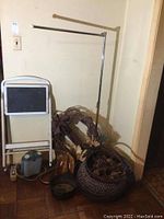 Photo showing overall items including step stool, heater, baskets, wreath, and metal clothes hanger