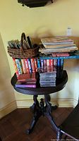 Overview of the table with stacked books and music CDs, showing the lot contents