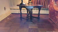 Full view of vintage wooden gateleg end table showing foldable side leaves and turned legs.